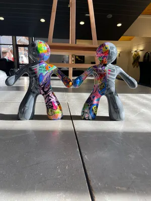 Sculptures Ni-Zu ( My sculptural series, Ni-Žu, features stylized human figures joined by hidden magnets in their hands — a symbol of biomagnetic connection and the invisible energy that links us all. One half is neutral grey — calm and balanced — the other, a vivid graffiti expression of love, peace, family, and respect.)